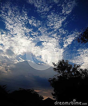 The view of the rising sun with sky full of clouds Stock Photo