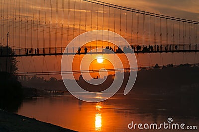 View of River Ganga and Ram Jhula bridge at sunset Stock Photo