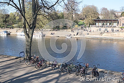 View of the River Ouse in York showing recreation areas and bikes on bike rack Editorial Stock Photo