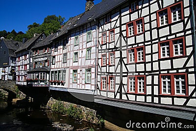 View on river with timber frame monument houses in center of medieval village Editorial Stock Photo