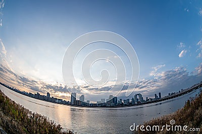 View of riverside with a blue sky, some plants and Umeda city in the background Editorial Stock Photo