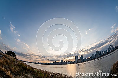 View of riverside with a blue sky, some plants and Umeda city in the background Editorial Stock Photo