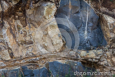 View of rocks broken down for construction in a hilly region. Remains of rock in a quarry Stock Photo
