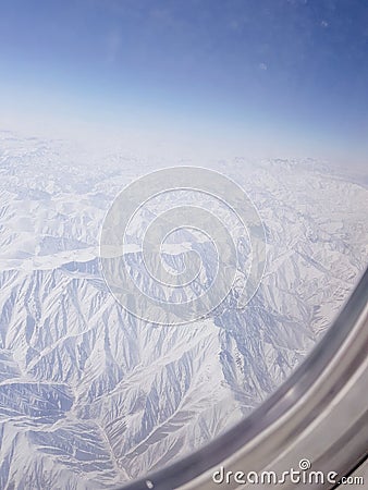 A view of rocks high up from the window of aeroplane Stock Photo