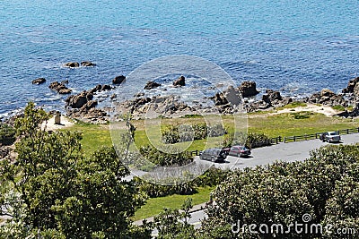 A view of the rocks and the Moai statue on the bank of Lyal Bay, Wellington, New Zealand Stock Photo