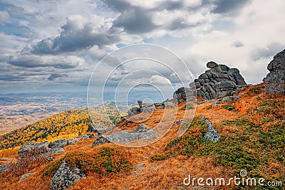 View of rocks and mountain taiga under clouds, autumn withered grass high in the mountains Stock Photo