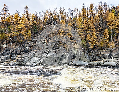 View of the rocky shore of the wild rapid Siberian river in autumn Stock Photo