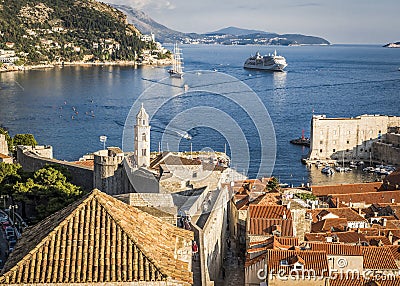 View of the roofs of houses and the bay with ships in the city of Dubrovnik in sunny summer Editorial Stock Photo