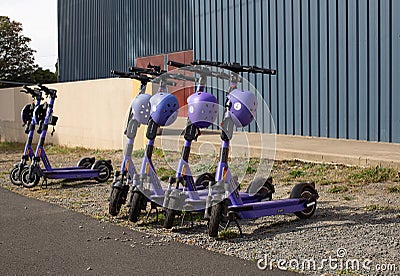 View of a row of parked rental electric scooters Editorial Stock Photo