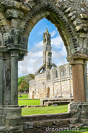 View of the ruined nave and tower of St Andrews Cathedral through a stone arch, in St Andrews, Scotland Editorial Stock Photo