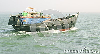 View of running wooden boat at deep river Editorial Stock Photo