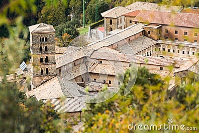 View of Saint Scholastica medieval monastery surrounded, by trees in Subiaco. Founded by Benedict of Nursia Stock Photo