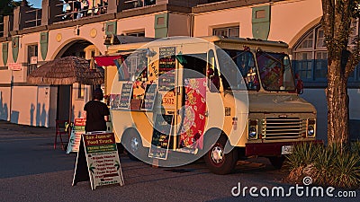 View of San Juan Food Truck selling Bolivan meals to pedestrians at English Bay Beach, Vancouver downtown in the evening light. Editorial Stock Photo