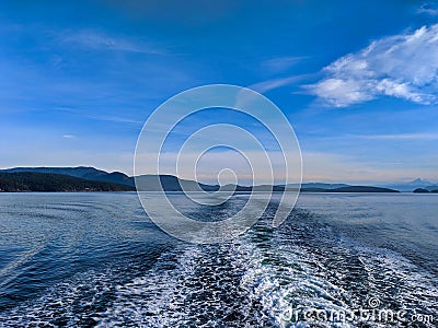 Close up of ocean water creating wakes and waves behind a ferry boat in the Pacific Ocean Stock Photo