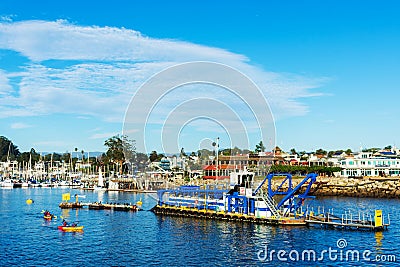 View of Santa Cruz Small Craft Harbor with DSC dredge Twin Lakes in harbor channel Editorial Stock Photo