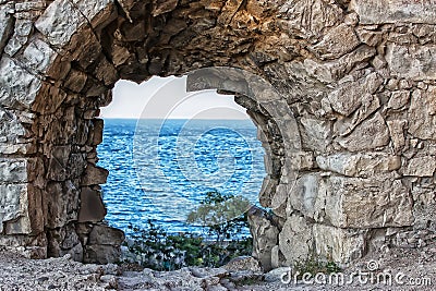 view of the sea through the loophole of the fortress Stock Photo