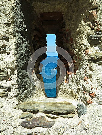 A view of the sea through the loophole of a medieval fort in the southern part of Colliure, France Stock Photo