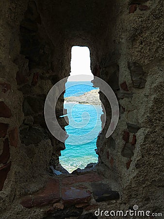 A view of the sea through the loophole of a medieval fort in the southern part of Colliure, France Stock Photo