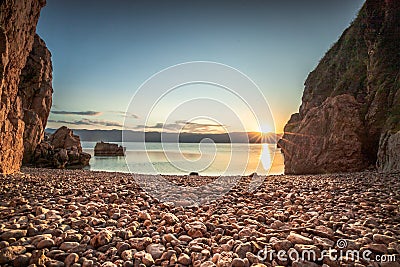 view of the sea in the sunrise, hidden stone beach at Vibnik Krk in Croatia Stock Photo