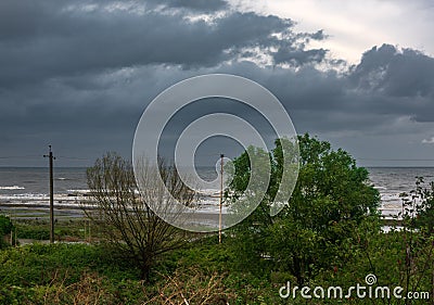 View of the seashore on a cloudy rainy day Stock Photo