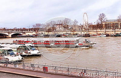 View of Seine river, ships, bridge, coast with ferris wheel in Paris. Stock Photo