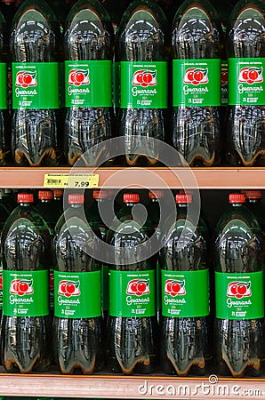 View of shelves full of the bottles of the soft drink Guarana energy drink in a supermarket in Brazil Editorial Stock Photo