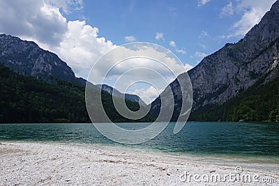 View from the shore of a pond to the mountains Stock Photo