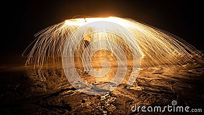 View of showers of glowing sparks from burning spinning steel wool Stock Photo