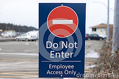 View of Sign Do Not Enter Employee Access Only on a Parking Lot Stock Photo