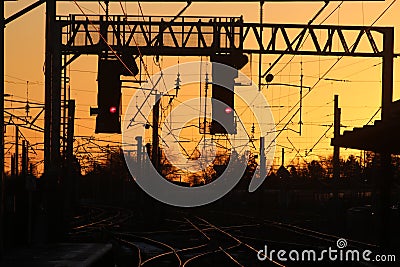 Signal gantry, red color lights, track at sunset Stock Photo