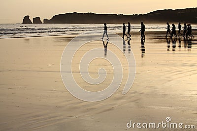 View on silhouette of group of people surfers heating up going to ocean in sunrise Editorial Stock Photo
