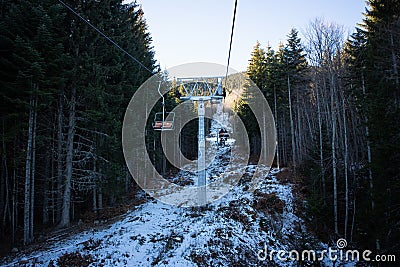 View from the skilifts from Goce Delcev hut to the Bezbog lake in PIrin Mountains in Bulgaria. Very old skilift on a snowy cold Stock Photo