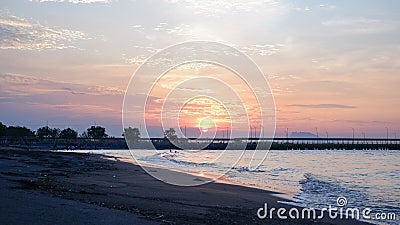 View of the silhouette of the bridge in the harbor during the evening sky as the sun soon sets. Stock Photo