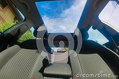 View of the sky from the open roof of the car. Stock Photo