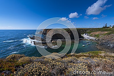 View of the small fishing port of Entrada da Barca from the surrounding cliffs, at Zambujeira do Mar in Odemira Stock Photo