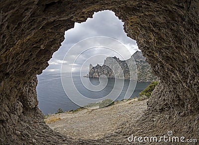 View from a small grotto onto the coastal cliffs. Stock Photo