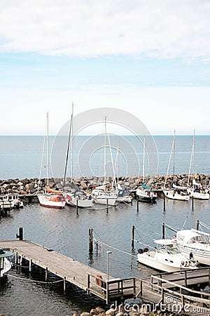 View of a small marina with fishing boats and yachts. Quiet harbor in the Baltic Sea Stock Photo