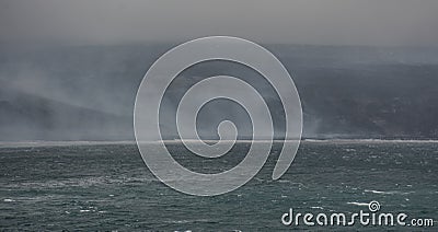 View of the smokey beach of Saunders Island, South Sandwich Islands - a remote island chain in the Atlantic Ocean Stock Photo