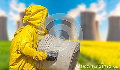 View of smoking coal power plant and men in protective hazmat suit Stock Photo