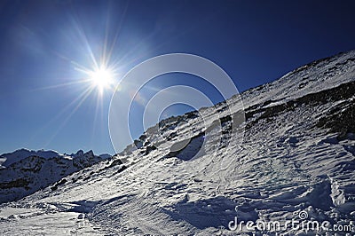View of snow mountains and ski slope in Switzerland Europe on a cold sunny day Stock Photo