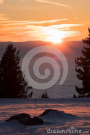 View from rocks on mountain to low stratus and sunset Stock Photo