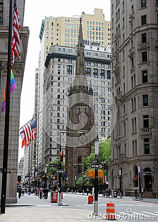 Broadway in downtown Financial District, steeple of the Trinity Church in the center, New York, NY Editorial Stock Photo