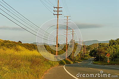 View of southern California highway lined by electrical utility poles. Stock Photo