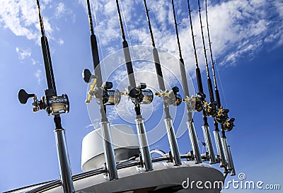 View of spinning rods prepared for fishing against the blue summer sky Stock Photo