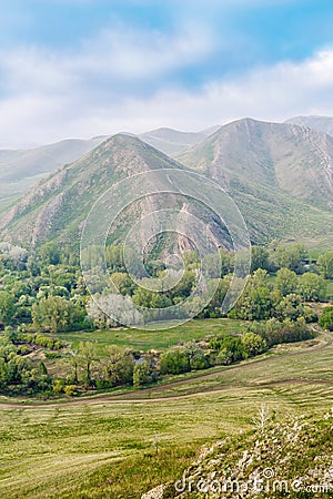 View of the spring mountain landscape through the misty haze. Andreevskie Cones Stock Photo