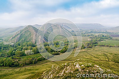 View of the spring mountain landscape through the misty haze. Andreevskie Cones Stock Photo