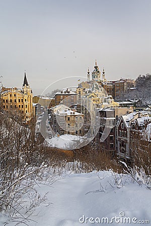 View of St. Andrew`s Church and the historical part of the city covered with snow. Kiev Stock Photo