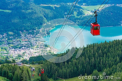 View of St.Gilgen and red Seilbahn cable car gondolas from Zwolferhorn mountain Stock Photo