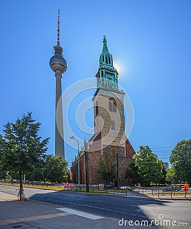 View on St. Marienkirche and Berlin television tower in back light during daytime in summer Editorial Stock Photo