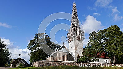 View on the St. Nicholas church, with tower in the scaffolding, in Kose Editorial Stock Photo